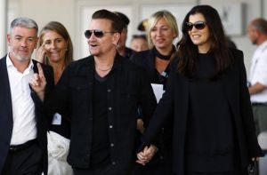 Irish singer Bono, lead singer of group U2, and his wife Hewson arrive to take a taxi boat transporting guests for the wedding of U.S. actor George Clooney and his fiancee Amal Alamuddin, in Venice